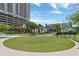 Putting green and seating area with meticulously manicured landscaping surrounded by tropical palm trees at 1120 E Kennedy Blvd # 1512, Tampa, FL 33602