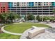 Synthetic putting green with custom seating and a modern landscape design in a vibrant community at 1120 E Kennedy Blvd # 1512, Tampa, FL 33602