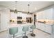 Bright kitchen with white cabinets, quartz countertops, stainless steel appliances, and modern pendant lighting at 1124 Creek Valley Ct, Brandon, FL 33511