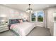 Sunlit main bedroom with serene views, decorative headboard, and modern chandelier at 1124 Creek Valley Ct, Brandon, FL 33511