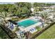 Aerial view of a community pool and sun-bathing area, surrounded by lush landscaping at 1124 Creek Valley Ct, Brandon, FL 33511