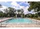 Relaxing pool with lounge chairs, tropical landscaping, and a pergola offers a resort-like experience at 1124 Creek Valley Ct, Brandon, FL 33511