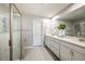 Bathroom featuring double sinks, a large mirror, and a glass-enclosed shower at 1126 Creek Valley Ct, Brandon, FL 33511