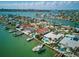 Stunning aerial view of waterfront homes, private docks and boats in clear, turquoise water on a sunny day at 11285 8Th E St, Treasure Island, FL 33706