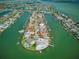 Bird's-eye view of luxurious waterfront homes with private docks on a serene canal at 11285 8Th E St, Treasure Island, FL 33706