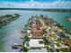 Panoramic aerial showcases luxurious waterfront homes with boat docks and serene bay views at 11285 8Th E St, Treasure Island, FL 33706