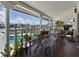 Covered back porch with terracotta tile, offering water views, seating, and outdoor dining options at 11285 8Th E St, Treasure Island, FL 33706
