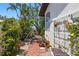 Secluded backyard patio with lush vegetation, perfect for quiet relaxation at 11285 8Th E St, Treasure Island, FL 33706