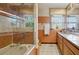 Bathroom features marble tiling and a shower/tub combination with glass door at 11285 8Th E St, Treasure Island, FL 33706