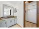 Bathroom vanity with a large mirror and adjacent closet, perfect for storage at 11285 8Th E St, Treasure Island, FL 33706