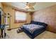 Cozy bedroom with unique ceiling fan, decorative wall finish, and comfortable furnishings at 11285 8Th E St, Treasure Island, FL 33706