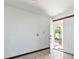 Bright entryway with white walls, tile flooring and a view of the outdoor space through an open door at 11285 8Th E St, Treasure Island, FL 33706