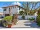 Charming two-story home with lush landscaping, red tile roof, and inviting curb appeal at 11285 8Th E St, Treasure Island, FL 33706