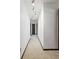 Neutral hallway featuring clean lines, neutral carpet, and track lighting providing access to other rooms at 11285 8Th E St, Treasure Island, FL 33706