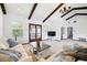 Bright living room with beamed ceilings, plush seating, and large windows offering inviting gathering space at 11285 8Th E St, Treasure Island, FL 33706