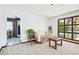 Bright living room with white sofa, wooden tables, and a glimpse of the kitchen through an arched doorway at 11285 8Th E St, Treasure Island, FL 33706