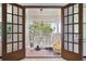 View of a cozy screened-in patio with outdoor seating, perfect for relaxation and enjoying the outdoors at 11285 8Th E St, Treasure Island, FL 33706