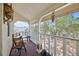 View of a cozy screened-in patio with outdoor seating, perfect for relaxation and enjoying the outdoors at 11285 8Th E St, Treasure Island, FL 33706