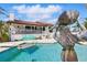 Refreshing pool and mermaid statue enhance the backyard of this beautiful home at 11285 8Th E St, Treasure Island, FL 33706
