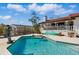 Backyard pool with clear water, diving board and mermaid statue, surrounded by a patio and landscaping at 11285 8Th E St, Treasure Island, FL 33706
