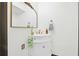 Stylish powder room with modern fixtures, elegant mirror, and white vanity offering a convenient amenity at 11285 8Th E St, Treasure Island, FL 33706