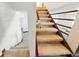 Carpeted staircase with wooden banister providing access to upper or lower levels of the home at 11285 8Th E St, Treasure Island, FL 33706