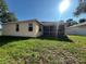 Back view of the home featuring a screened in porch, privacy fence, and lush green grass at 11420 Bridge Pine Dr, Riverview, FL 33569