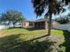 Backyard featuring green grass, a privacy fence, and a screened in porch at 11420 Bridge Pine Dr, Riverview, FL 33569