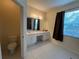 Bright bathroom with double vanity, tile floors, and plenty of natural light at 11420 Bridge Pine Dr, Riverview, FL 33569