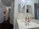 Bathroom featuring a sink with brushed nickel faucet, and a view down the hallway at 11420 Bridge Pine Dr, Riverview, FL 33569