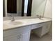 Bathroom featuring a double vanity with two sinks and white cabinets with matching drawers at 11420 Bridge Pine Dr, Riverview, FL 33569