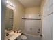 Bathroom with a shower-tub combo, tiled walls, and a functional vanity at 11420 Bridge Pine Dr, Riverview, FL 33569