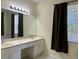Bright bathroom featuring a double vanity, updated fixtures, and natural light from a nearby window at 11420 Bridge Pine Dr, Riverview, FL 33569