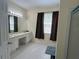 Well-lit bathroom featuring a long vanity with dual sinks and shower with clear glass doors at 11420 Bridge Pine Dr, Riverview, FL 33569