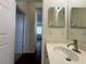 Bathroom featuring a sink with brushed nickel faucet, and a view down the hallway at 11420 Bridge Pine Dr, Riverview, FL 33569