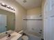 Clean bathroom featuring a white-tiled shower and a well-lit vanity at 11420 Bridge Pine Dr, Riverview, FL 33569