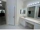 Bright bathroom featuring dual sinks, marble countertops, and a shower with glass doors at 11420 Bridge Pine Dr, Riverview, FL 33569