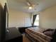 This cozy bedroom includes a ceiling fan, closet, and window with natural light at 11420 Bridge Pine Dr, Riverview, FL 33569