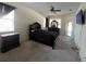 Spacious main bedroom with dark wood furniture set, ceiling fan and carpeted floor offers a relaxing retreat at 11420 Bridge Pine Dr, Riverview, FL 33569
