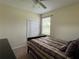 Bedroom featuring neutral walls, striped bedding and large window with blinds and carpeted floor at 11420 Bridge Pine Dr, Riverview, FL 33569