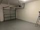 View of a clean garage with an automatic door and painted concrete floor at 11420 Bridge Pine Dr, Riverview, FL 33569