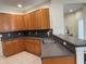Spacious kitchen featuring wooden cabinets, granite countertops, and a stainless steel sink at 11420 Bridge Pine Dr, Riverview, FL 33569