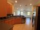 Open kitchen featuring wood cabinets, dark countertops and stainless steel appliances at 11420 Bridge Pine Dr, Riverview, FL 33569