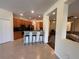Eat-in kitchen with wood cabinets, stainless appliances, breakfast bar and three stools at 11420 Bridge Pine Dr, Riverview, FL 33569