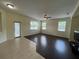 Bright living room with large windows, dual flooring, and a glass sliding door at 11420 Bridge Pine Dr, Riverview, FL 33569