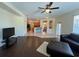 Spacious living room featuring a ceiling fan and an open floor plan to the kitchen at 11420 Bridge Pine Dr, Riverview, FL 33569