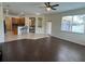 Open-concept living room with kitchen view, featuring dark wood-look floors and tile flooring at 11420 Bridge Pine Dr, Riverview, FL 33569