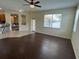 Open living room showcasing ceramic tile flooring and seamless transition to dark hardwood floors at 11420 Bridge Pine Dr, Riverview, FL 33569