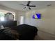 Spacious main bedroom with ceiling fan, TV, and access to the lanai at 11420 Bridge Pine Dr, Riverview, FL 33569