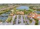 An aerial view showcases a community with a lake, golf course, tennis courts, pool, and clubhouse at 12672 Fontana Loop, Bradenton, FL 34211
